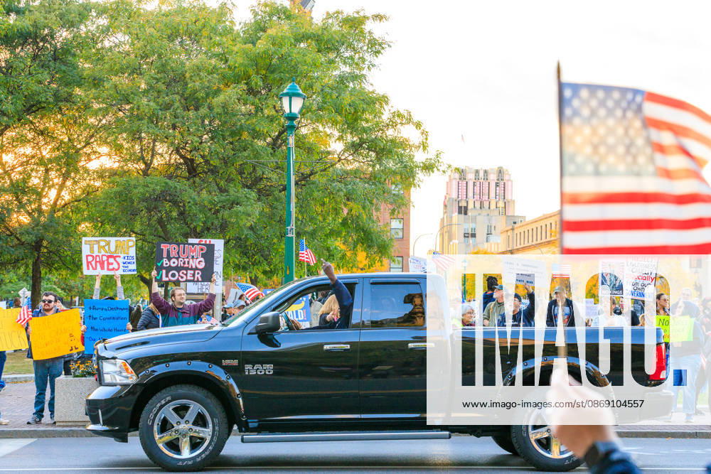 A Trump supportor gives protestors the middle finger. Syracuse USA - ZUMAh195 20261009_znp_h195_014