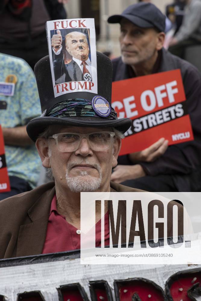 A demonstrator wears a hat with an image of President Trump with a Hitler moustache that reads FUCK TRUMP at the Hands Off NYC coalition emergency protest outside Federal Plaza in Lower Manhattan demanding justice the day following ICE shooting a Bronx man while his 5 year child was in the car. New York USA - ZUMAr174 20261009_znp_r174_006