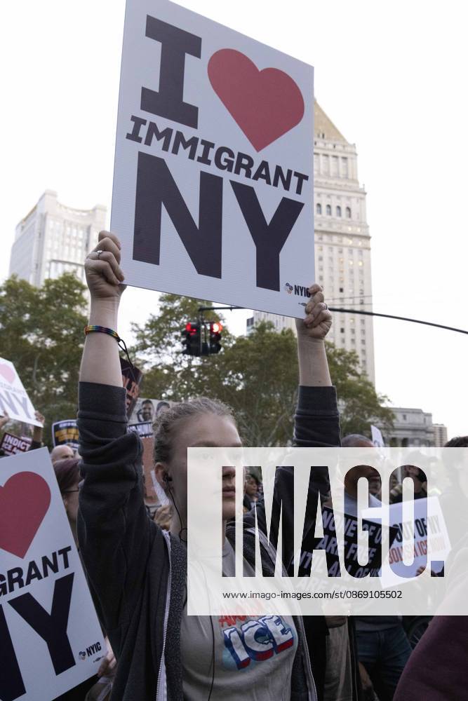 A demonstrator wears a shirt that reads Abolish ICE and holds a sign that reads I love IMMIGRANT NY marching through the streets of Lower Manhattan at the Hands Off NYC coalition emergency protest demanding justice the day following ICE shooting a Bronx man while his 5 year child was in the car. New York USA - ZUMAr174 20261009_znp_r174_029