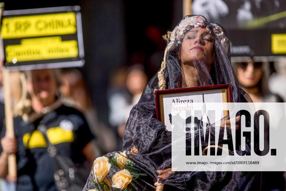 Protest in Madrid on the Day Against the Death Penalty - 10 Oct 2026 A woman holds a portrait, wearing a veil on her head during a rally against the death penalty in Callao Square in central Madrid. World Day Against the Death Penalty has been observed every October 10th since 2003. Madrid Spain