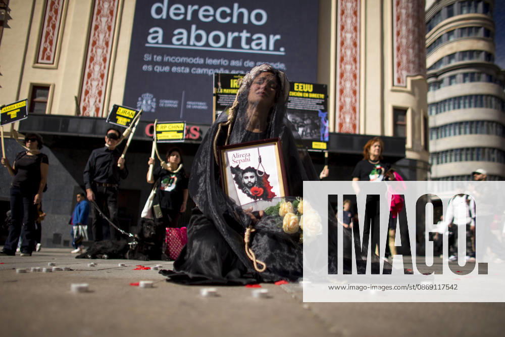 A woman holds a portrait, wearing a veil on her head during a rally against the death penalty in Callao Square in central Madrid. World Day Against the Death Penalty has been observed every October 10th since 2003. Madrid Spain - ZUMAs197 20261010_aaa_s197_019