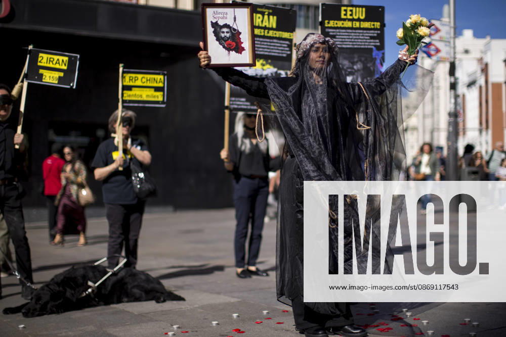 A woman holds a portrait, wearing a veil on her head during a rally against the death penalty in Callao Square in central Madrid. World Day Against the Death Penalty has been observed every October 10th since 2003. Madrid Spain - ZUMAs197 20261010_aaa_s197_020
