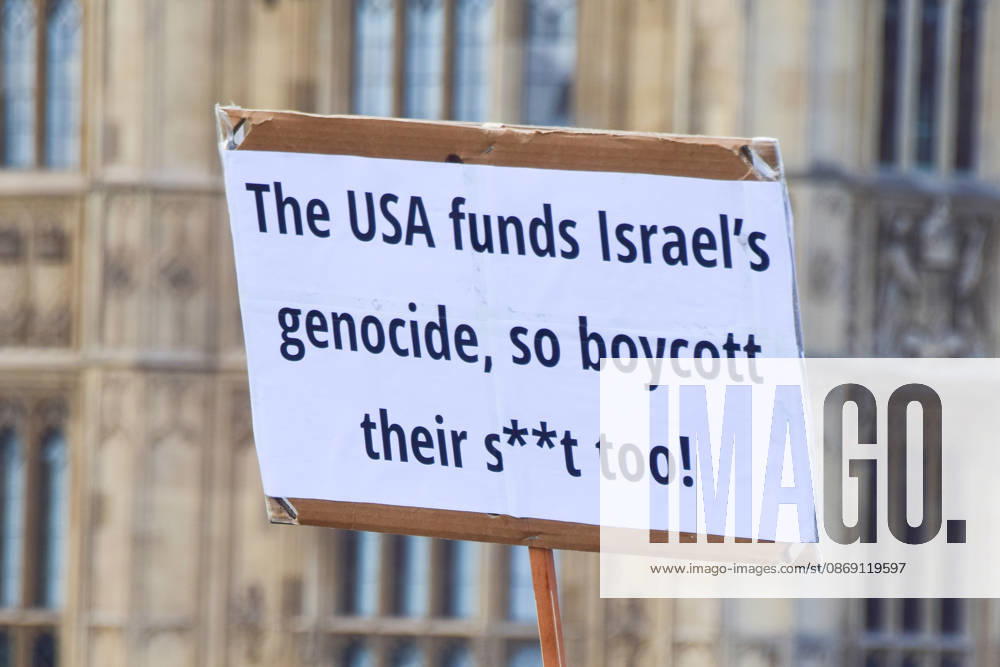 A protester on Westminster Bridge holds a sign calling for a boycott of the USA as thousands of people march in support of Palestine. The protesters also called on the government to stop arming Israel and for sanctions on Israel. London United Kingdom - ZUMAv130 20261010_zip_v130_040