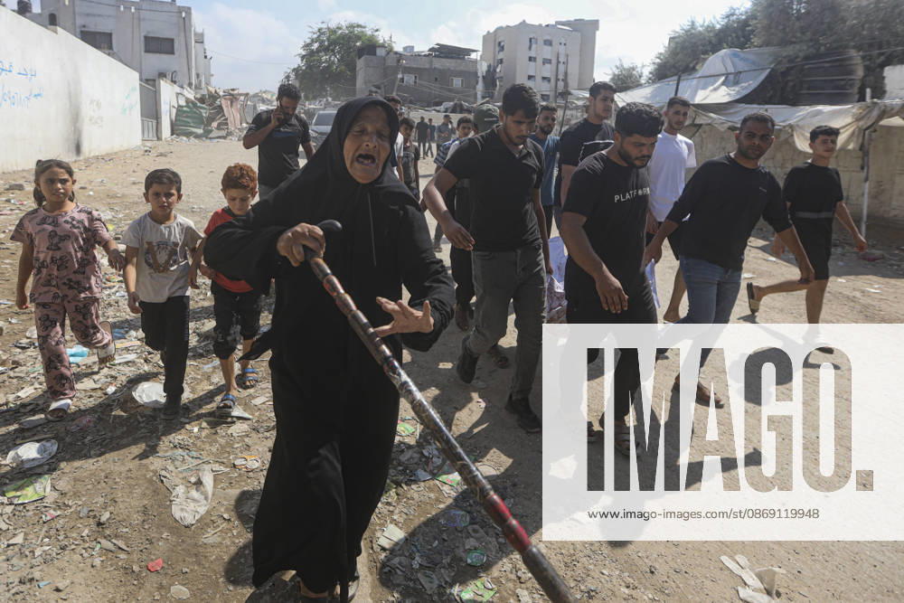 Gaza Palestine Airstrike Aftermath An elderly woman walks ahead of mourners carrying a shrouded body in Gaza City, Palestine on October 10, 2026. Four Palestinians were killed in an air strike near Panda Mall, and people carried the victims toward Al-Shifa Hospital for funeral prayers. Gaza Gaza Strip Palestinian Territories