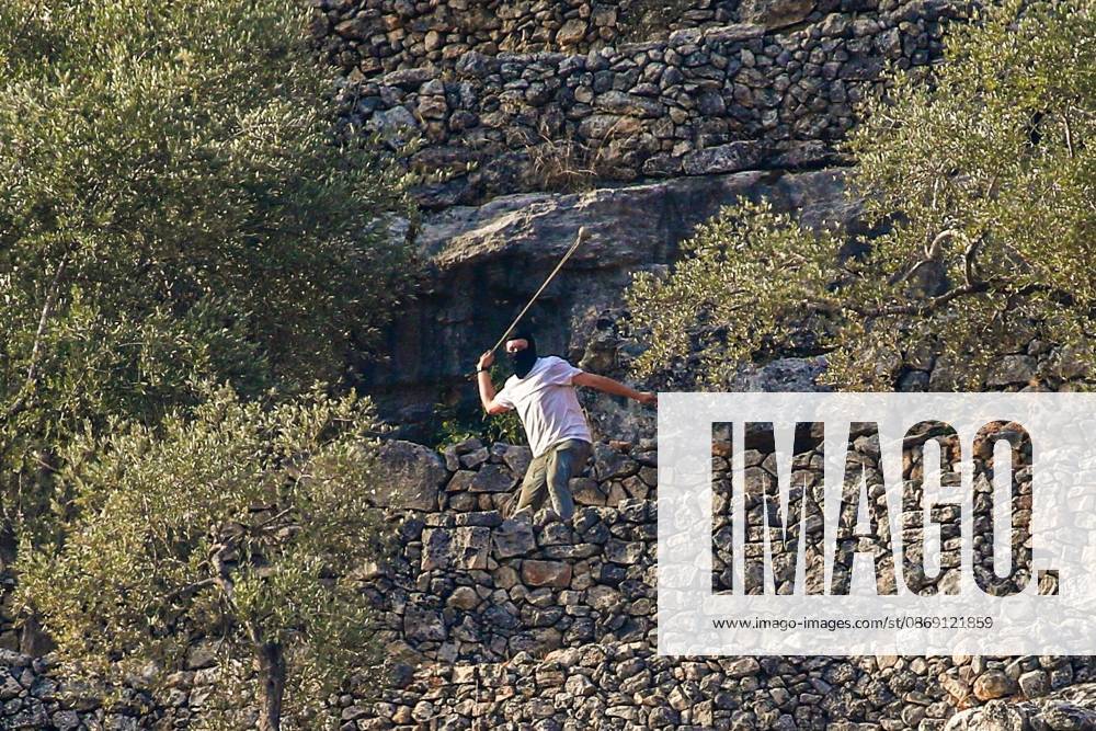 DEIR ABU MASHâ€⠢AL, PALESTINE †OCTOBER 10, 2026: Palestinian farmers came under attack by Israeli settlers and Israeli forces as they headed to harvest olives on their land in Deir Abu Mashâ€⠢al, northwest of Ramallah. The event marked the villageâ€⠢s first olive harvest gathering of the new season. The Palestine Red Crescent Society reported that its teams treated nine people injured during the incident. The injuries included one caused by live ammunition to the thigh, two caused by rubber-coated metal bullets, and six resulting from physical assault. One of those struck by a rubber-coated metal bullet was photojournalist Issam Al-Rimawi. The incident occurred during the annual olive harve - ZUMAq101 20261010_zna_q101_073