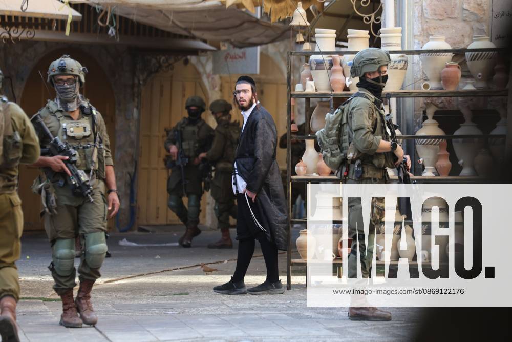 Israeli settlers enter Hebron Old City under military protection HEBRON, OCCUPIED WEST BANK, OCTOBER 10, 2026: Israeli settlers enter Hebron s Old City under the protection of Israeli forces during an organized visit to the area. Israeli soldiers deployed along streets and around the group as settlers moved through the Old City, where Israeli settlers and Palestinian residents live in close proximity amid longstanding tensions and movement restrictions. HEBRON Palestine, State of