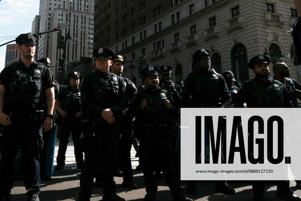 Members of the NYPD look on at protesters at an anti-ICE protest in Herald Square on October 10, 2026 in New York City. Protesters take to the streets following an incident where ICE agents shot a 28-year-old-man, Oscar Belgal while he in a vehicle with his 5-year old child in the Marble Hill neighborhood in the Bronx. New York USA - ZUMAb148 20261010_zap_b148_048