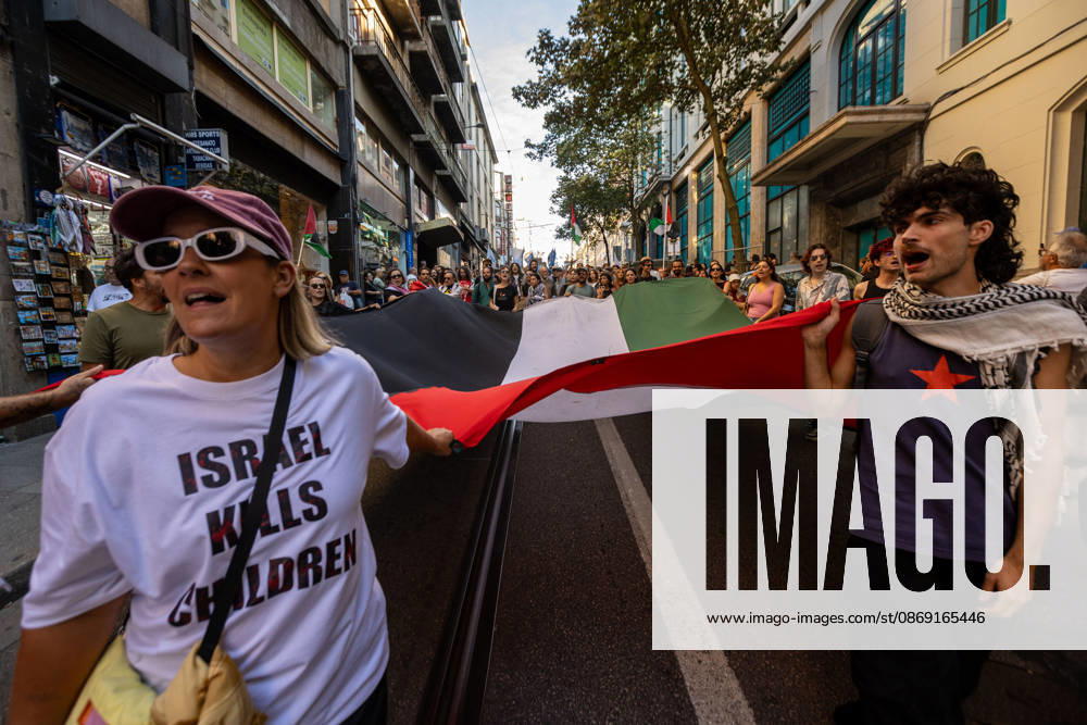 Palestine Solidarity March in Porto - 10 Oct 2026 Demonstrators carry a large Palestinian flag while marching through central Porto during a Palestine solidarity demonstration. Hundreds of demonstrators gathered in Porto for a Palestine solidarity march calling for an end to the war in Gaza and support for Palestinian rights. The march began at Praça dos Poveiros and concluded at Praça D. João I. Porto Portugal