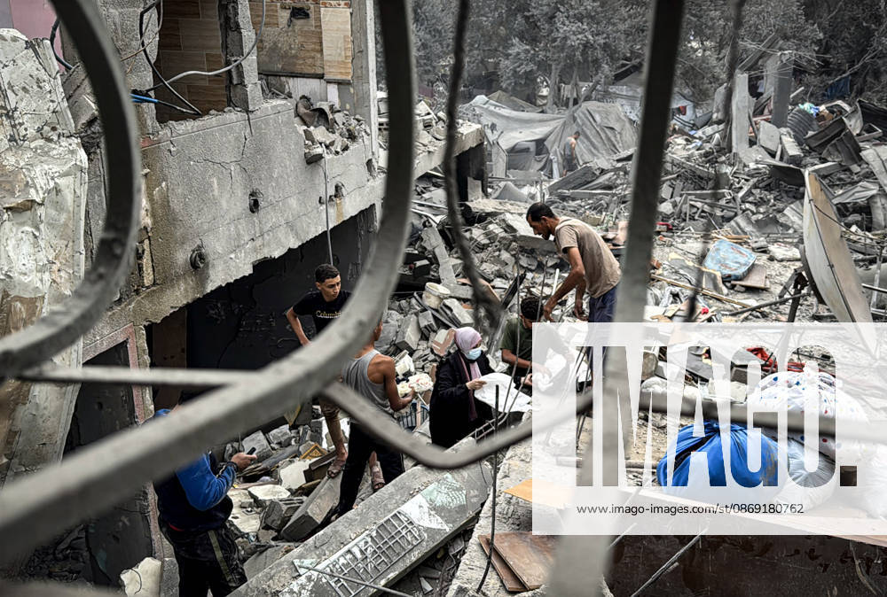 Palestinians Inspect Damage After Strike in Deir al-Balah Palestinians inspect their belongings amid the rubble of damaged residential buildings and their displacement tents after an Israeli airstrike targeted a house in Deir al-Balah, in the central Gaza Strip, on October 11, 2026. Photo by Ahmed Ibrahim apaimages Deir al-Balah Gaza Palestinian Territory 111026_Deir_al-Balah_AI_00(14)