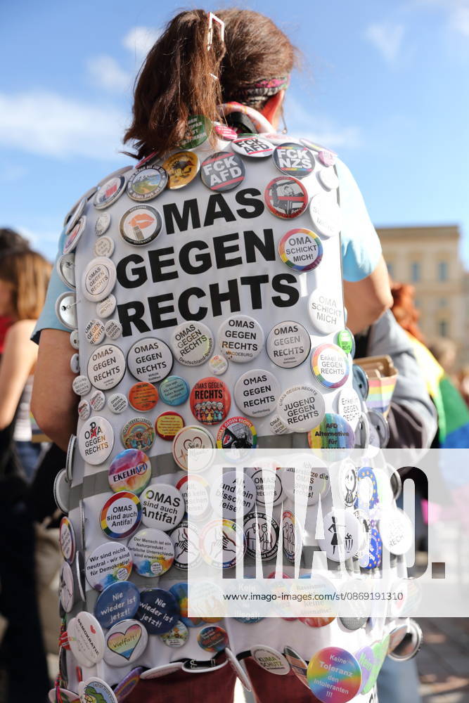A protester stands in the Old Market Square wearing a Grandmas Against the Right pin during a demonstration calling for the Federal Constitutional Court to review far-right parties, Potsdam, October 10, 2026. Protest in Potsdam