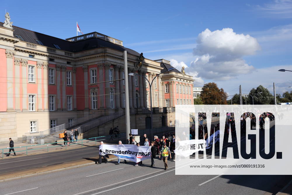 Protesters march with banners reading Brandenburg: Review and Review Today, Protect Tomorrow outside the state parliament during a demonstration calling for the Federal Constitutional Court to review far-right parties, Potsdam, October 10, 2026. Review Demonstration in Potsdam