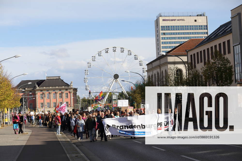 Protesters walk down Breite Straße carrying a banner reading Brandenburg: Investigate during a demonstration calling for the Federal Constitutional Court to review far-right parties, Potsdam, October 10, 2026. Investigate demonstration in Potsdam