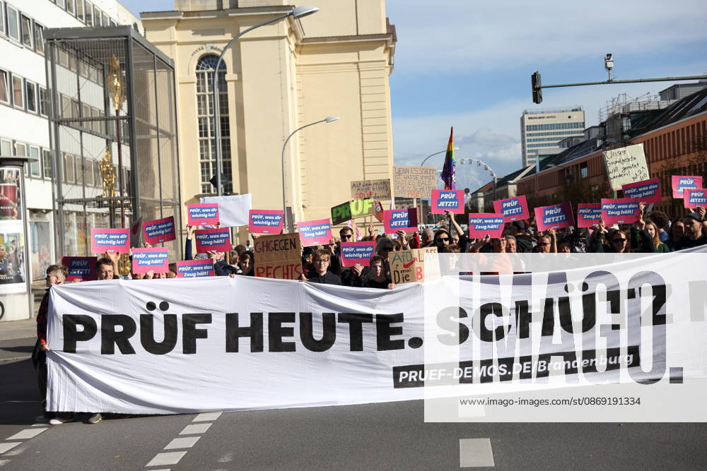 Protesters stand on Breite Straße holding a banner reading Review Today, Ban Tomorrow during a demonstration calling for the Federal Constitutional Court to review far-right parties, Potsdam, October 10, 2026. Review Demonstration in Potsdam