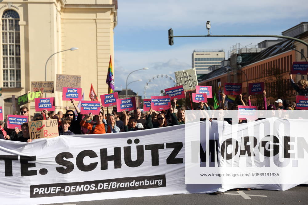 Protesters stand on Breite Straße holding a banner reading Review Today, Ban Tomorrow during a demonstration calling for the Federal Constitutional Court to review far-right parties, Potsdam, October 10, 2026. Review Demonstration in Potsdam