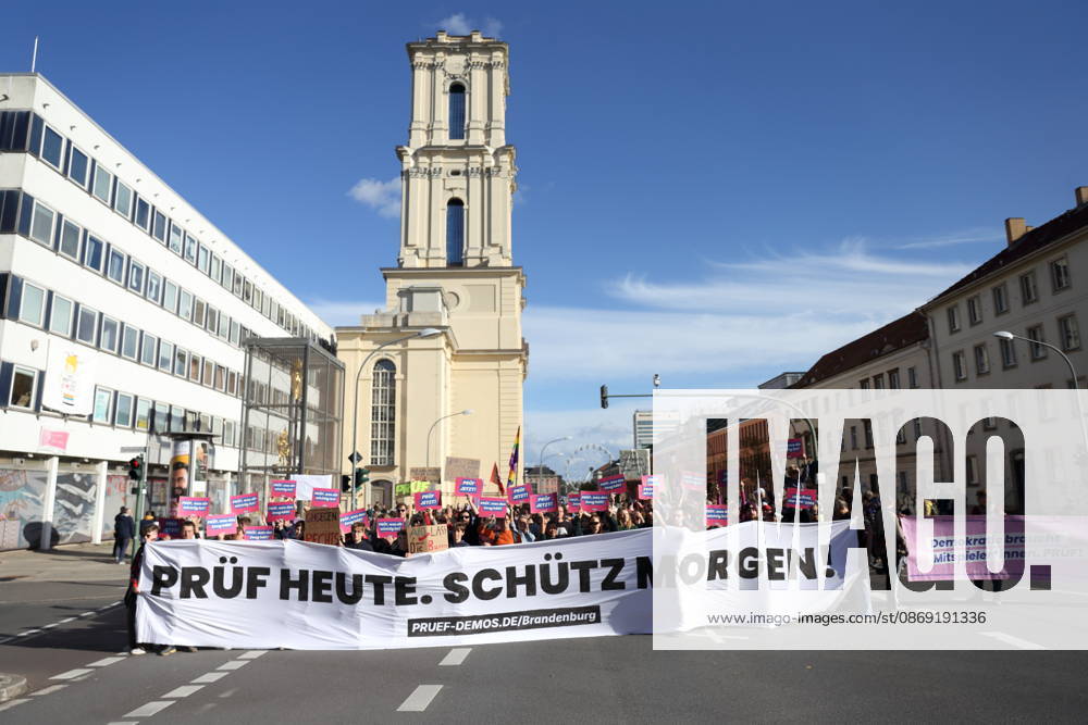 Protesters stand on Breite Straße holding a banner reading Review Today, Ban Tomorrow during a demonstration calling for the Federal Constitutional Court to review far-right parties, Potsdam, October 10, 2026. Review Demonstration in Potsdam