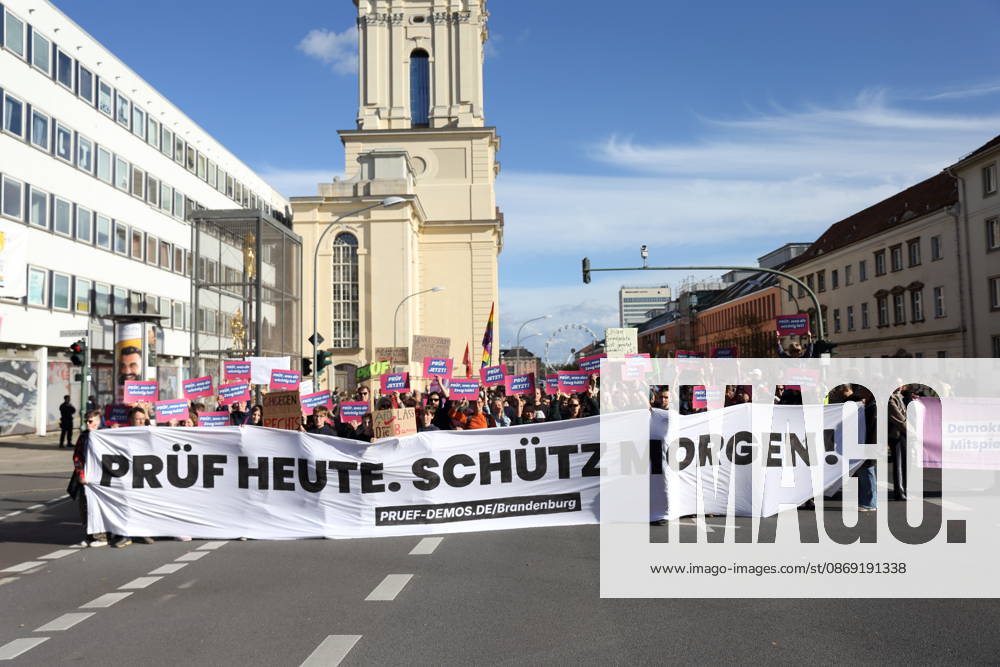 Protesters stand on Breite Straße holding a banner reading Review Today, Ban Tomorrow during a demonstration calling for the Federal Constitutional Court to review far-right parties, Potsdam, October 10, 2026. Review Demonstration in Potsdam