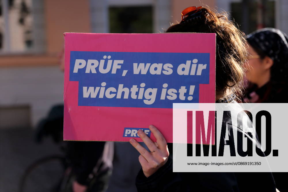 A protester walks down Charlottenstraße holding a sign that reads Check what’s important to you during a demonstration calling for the Federal Constitutional Court to review far-right parties, Potsdam, October 10, 2026. Check demonstration in Potsdam