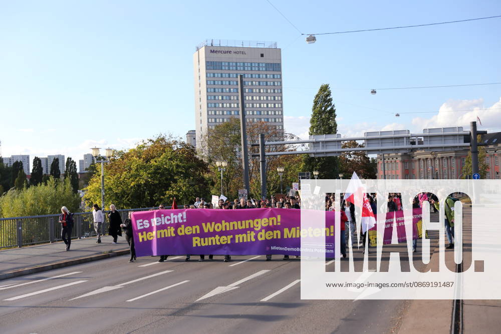 Protesters march across the Lange Bridge carrying a banner reading Enough Is Enough—Give Us Housing, Lower the Rents during a demonstration against the housing crisis and rising rents, Potsdam, October 10, 2026. Rent Protest in Potsdam