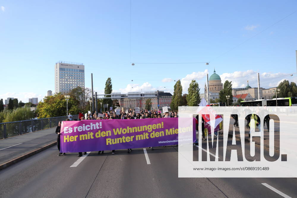Protesters march across the Lange Bridge carrying a banner reading Enough Is Enough—Give Us Housing, Lower the Rents during a demonstration against the housing crisis and rising rents, Potsdam, October 10, 2026. Rent Protest in Potsdam