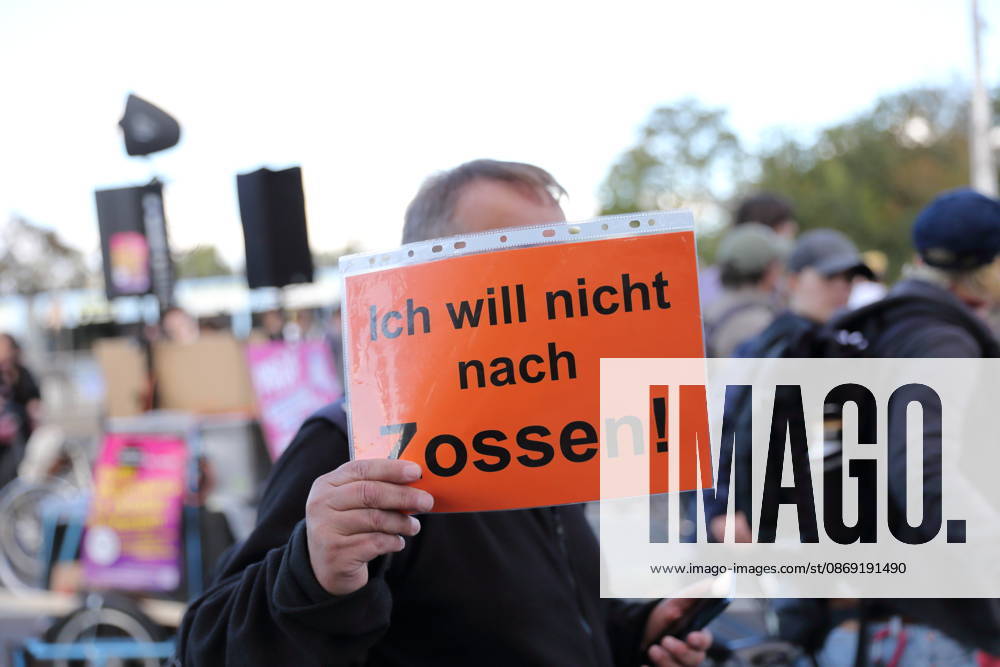 A protester walks across the Lange Brücke carrying a sign that reads I don’t want to go to Zossen during a demonstration against the housing crisis and rising rents, Potsdam, October 10, 2026. Rent Protest in Potsdam