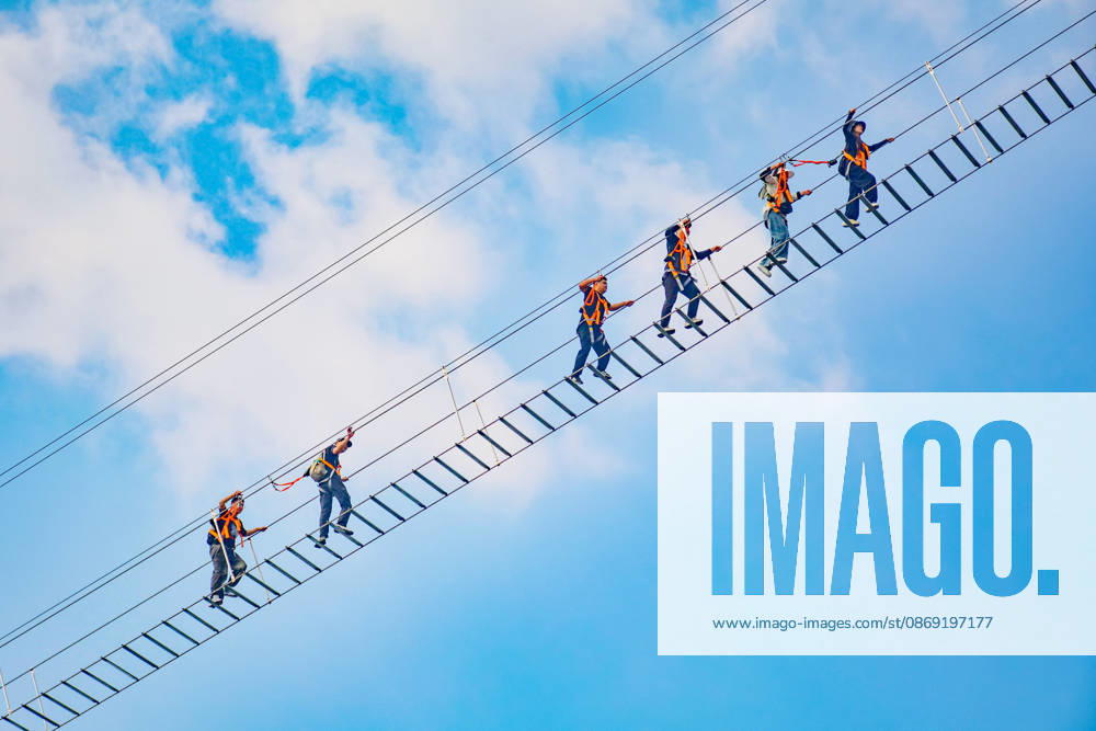 China Sky Ladder Challenger Tourists climb up a 250-meter-long soft ladder between two mountains in Mingtangshan Scenic Area in Yuexi county in central China s Anhui province, Sunday, Oct. 11, 2026. The rope ladder has 620 steps and a vertical distance of 365 meters. It opened to tourists in June this year, and quickly became a tourist attraction., Credit:stringer Utuku Feature China Avalon CHINA, ANHUI, YUEXI