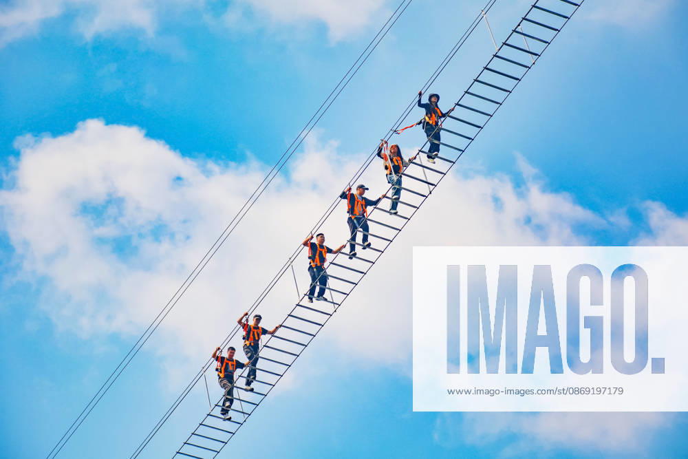 China Sky Ladder Challenger Tourists climb up a 250-meter-long soft ladder between two mountains in Mingtangshan Scenic Area in Yuexi county in central China s Anhui province, Sunday, Oct. 11, 2026. The rope ladder has 620 steps and a vertical distance of 365 meters. It opened to tourists in June this year, and quickly became a tourist attraction., Credit:stringer Utuku Feature China Avalon CHINA, ANHUI, YUEXI
