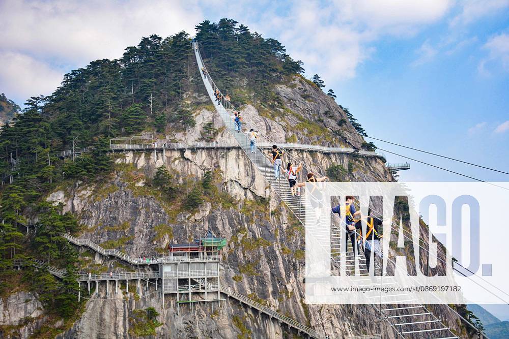 China Sky Ladder Challenger Tourists climb up a 250-meter-long soft ladder between two mountains in Mingtangshan Scenic Area in Yuexi county in central China s Anhui province, Sunday, Oct. 11, 2026. The rope ladder has 620 steps and a vertical distance of 365 meters. It opened to tourists in June this year, and quickly became a tourist attraction., Credit:stringer Utuku Feature China Avalon CHINA, ANHUI, YUEXI