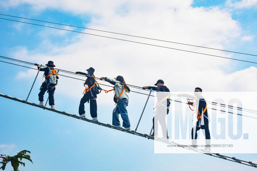 China Sky Ladder Challenger Tourists climb up a 250-meter-long soft ladder between two mountains in Mingtangshan Scenic Area in Yuexi county in central China s Anhui province, Sunday, Oct. 11, 2026. The rope ladder has 620 steps and a vertical distance of 365 meters. It opened to tourists in June this year, and quickly became a tourist attraction., Credit:stringer Utuku Feature China Avalon CHINA, ANHUI, YUEXI