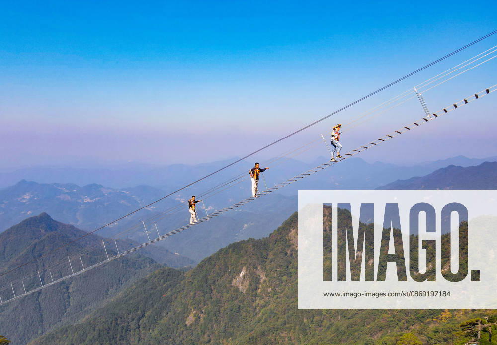 China Sky Ladder Challenger Tourists climb up a 250-meter-long soft ladder between two mountains in Mingtangshan Scenic Area in Yuexi county in central China s Anhui province, Sunday, Oct. 11, 2026. The rope ladder has 620 steps and a vertical distance of 365 meters. It opened to tourists in June this year, and quickly became a tourist attraction., Credit:stringer Utuku Feature China Avalon CHINA, ANHUI, YUEXI