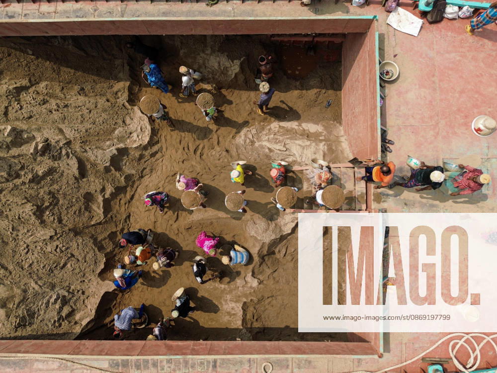 Migrant Workers Unload Sand Workers unload sand at a riverside site in Gabtoli, Dhaka, Bangladesh, on October 11, 2026. Many have left rural communities in search of employment in the capital, where daily labor provides a source of income but often involves strenuous work and limited financial security. Dhaka Bangladesh