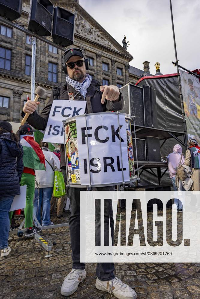 Amsterdam, Noord-Holland, The Netherlands: October 11, 2026, Amsterdam, Netherlands: A demonstrator carries a drum displaying the slogan FCK ISRL during a pro-Palestinian protest at Dam Square. The demonstration calls for sanctions against Israel and a permanent ceasefire in Gaza. Amsterdam The Netherlands - ZUMAl165 20261011_zip_l165_014