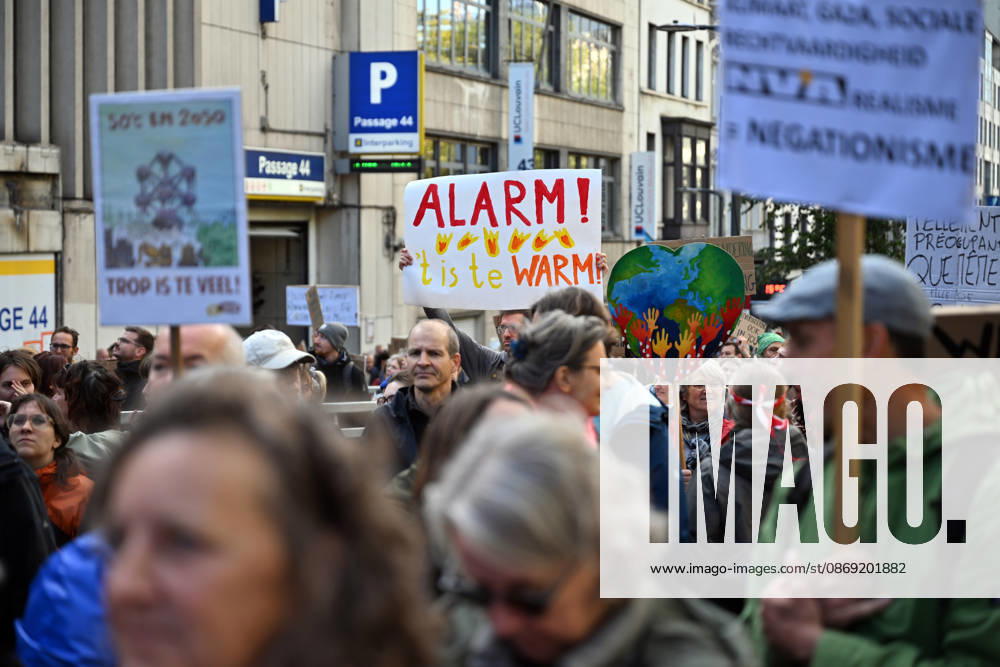 Tens of thousands march in Brussels demanding stronger climate action BRUSSELS, BELGIUM - OCTOBER 11: Demonstrators hold climate-themed placards as tens of thousands of people march through Brussels calling for stronger action against climate change and reduced dependence on fossil fuels, on October 11, 2026 in Brussels, Belgium. The protest was organized by the Belgian Climate Coalition, which brings together around 100 civil society organizations. Participants marched along major roads toward Schuman Square, home to several European Union institutions, while protesting the government s climate policies. Dursun Aydemir Anadolu Brussels Belgium. Editorial use only. Please get in touch for any other usage.