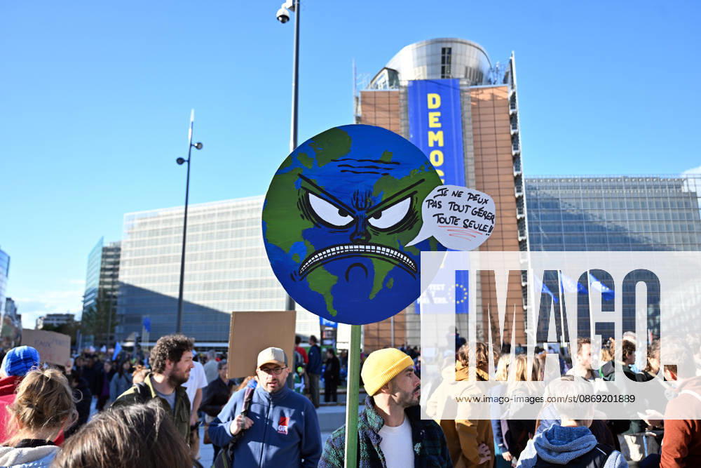Tens of thousands march in Brussels demanding stronger climate action BRUSSELS, BELGIUM - OCTOBER 11: Demonstrators hold climate-themed placards as tens of thousands of people march through Brussels calling for stronger action against climate change and reduced dependence on fossil fuels, on October 11, 2026 in Brussels, Belgium. The protest was organized by the Belgian Climate Coalition, which brings together around 100 civil society organizations. Participants marched along major roads toward Schuman Square, home to several European Union institutions, while protesting the government s climate policies. Dursun Aydemir Anadolu Brussels Belgium. Editorial use only. Please get in touch for any other usage.