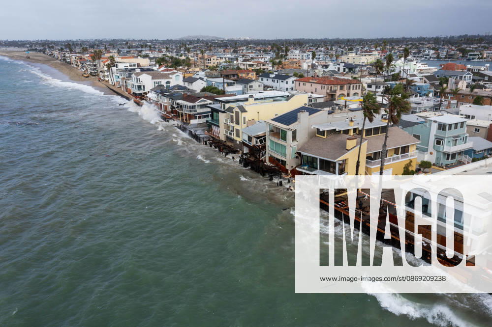 The Long Beach Peninsula is facing severe, structural devastation as Tropical Storm Rachel batters the Southern California coast. Driven by a developing El Nino pattern, this is the fourth major storm system to slam the shoreline in six weeks. Waves and unusually high tides have shattered a 30-foot section of the protective wooden bulkhead, completely shredding the historic boardwalk and allowing seawater to surge directly onto interior streets. Flooding has swamped coastal neighborhoods, forcing mandatory evacuations along oceanfront blocks like Seaside Walk. Emergency crews are working to stack thousands of sandbags and reinforce coastal defenses, but city inspectors have already been forced - ZUMAr19_ 20261011_new_r19_125