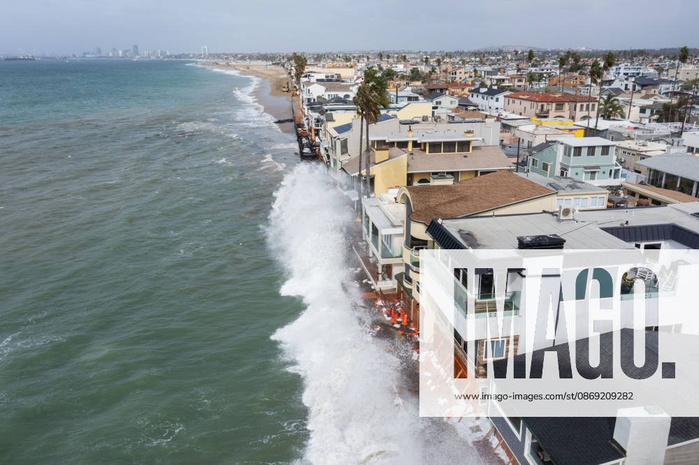 The Long Beach Peninsula is facing severe, structural devastation as Tropical Storm Rachel batters the Southern California coast. Driven by a developing El Nino pattern, this is the fourth major storm system to slam the shoreline in six weeks. Waves and unusually high tides have shattered a 30-foot section of the protective wooden bulkhead, completely shredding the historic boardwalk and allowing seawater to surge directly onto interior streets. Flooding has swamped coastal neighborhoods, forcing mandatory evacuations along oceanfront blocks like Seaside Walk. Emergency crews are working to stack thousands of sandbags and reinforce coastal defenses, but city inspectors have already been forced - ZUMAr19_ 20261011_new_r19_129