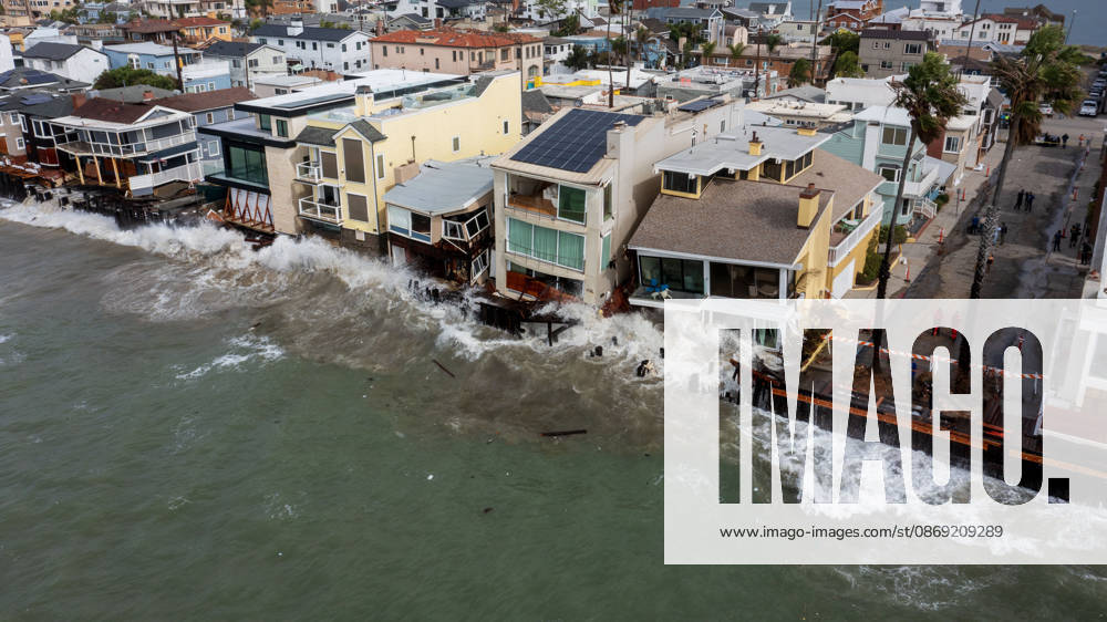 The Long Beach Peninsula is facing severe, structural devastation as Tropical Storm Rachel batters the Southern California coast. Driven by a developing El Nino pattern, this is the fourth major storm system to slam the shoreline in six weeks. Waves and unusually high tides have shattered a 30-foot section of the protective wooden bulkhead, completely shredding the historic boardwalk and allowing seawater to surge directly onto interior streets. Flooding has swamped coastal neighborhoods, forcing mandatory evacuations along oceanfront blocks like Seaside Walk. Emergency crews are working to stack thousands of sandbags and reinforce coastal defenses, but city inspectors have already been forced - ZUMAr19_ 20261011_new_r19_130