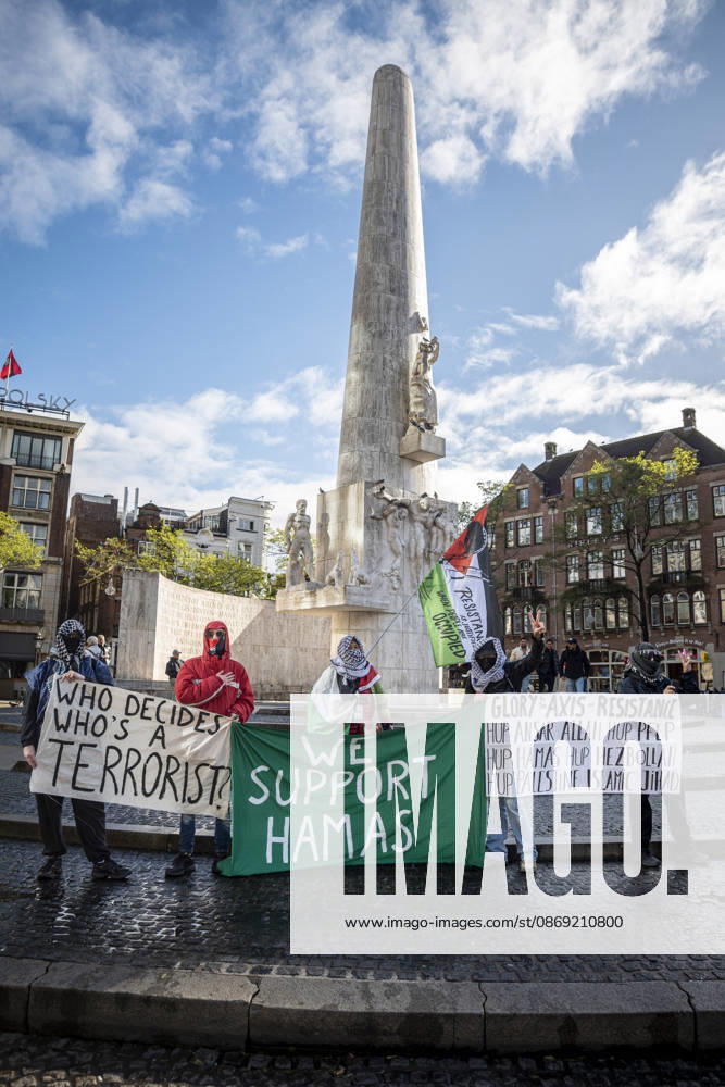Amsterdam, North Holland, The Netherlands - Holland: 11 October 2026, Amsterdam, the Netherlands: Protesters hold pro-Hamas banners at the National Monument on The Dam. Protesters gathered at Dam Square for speeches and anti-war music before marching through AmsterdamÃ¢â‚¬â ¢s city centre in a demonstration dubbed Ã¢â‚¬oeThree Years of GenocideÃ¢â‚¬Â. The event marked three years since the start of the IsraelÃ¢â‚¬Hamas war. Demonstrators carried Palestinian flags and banners, demanding the Dutch government act against what they describe as a genocide in Gaza. Amsterdam The Netherlands - Holland - ZUMAp202 20261011_zip_p202_002