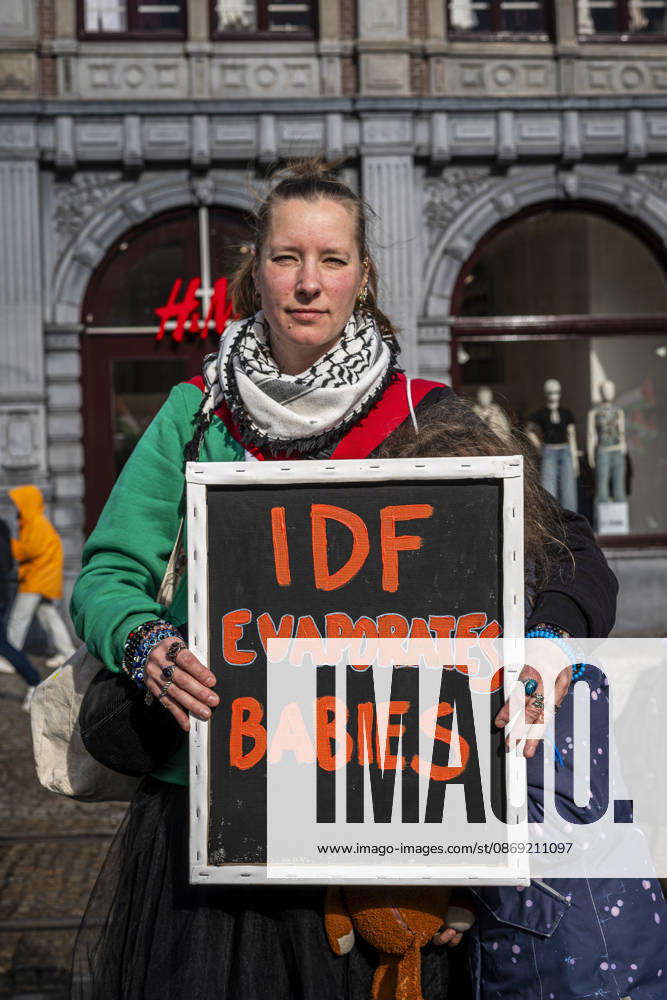 Amsterdam, North Holland, The Netherlands - Holland: 11 October 2026, Amsterdam, the Netherlands: A Protester holds a sign reading Ã¢â‚¬oeIDF Evaporates BabiesÃ¢â‚¬Â. Protesters gathered at Dam Square for speeches and anti-war music before marching through AmsterdamÃ¢â‚¬â ¢s city centre in a demonstration dubbed Ã¢â‚¬oeThree Years of GenocideÃ¢â‚¬Â. The event marked three years since the start of the IsraelÃ¢â‚¬Hamas war. Demonstrators carried Palestinian flags and banners, demanding the Dutch government act against what they describe as a genocide in Gaza. Amsterdam The Netherlands - Holland - ZUMAp202 20261011_zip_p202_004