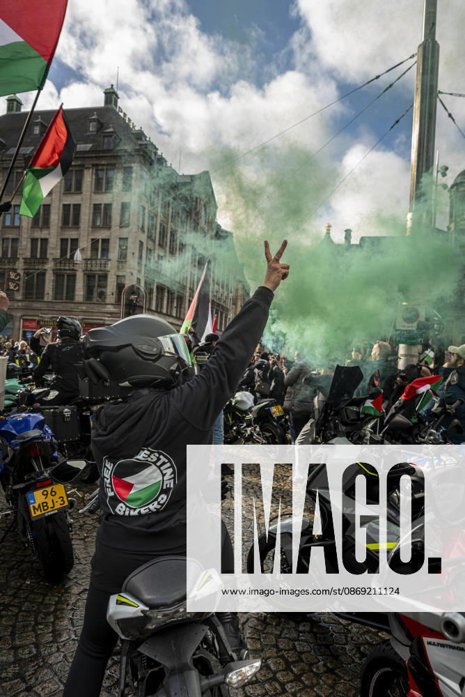 Amsterdam, North Holland, The Netherlands - Holland: 11 October 2026, Amsterdam, the Netherlands: Bikers for Palestine members set off smoke flares at Dam Square. Protesters gathered at Dam Square for speeches and anti-war music before marching through AmsterdamÃ¢â‚¬â ¢s city centre in a demonstration dubbed Ã¢â‚¬oeThree Years of GenocideÃ¢â‚¬Â. The event marked three years since the start of the IsraelÃ¢â‚¬Hamas war. Demonstrators carried Palestinian flags and banners, demanding the Dutch government act against what they describe as a genocide in Gaza. Amsterdam The Netherlands - Holland - ZUMAp202 20261011_zip_p202_010