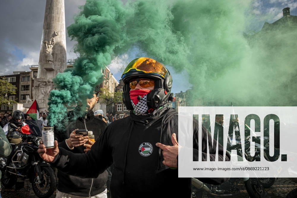 Bikers for Palestine members set off smoke flares at Dam Square. Protesters gathered at Dam Square for speeches and anti-war music before marching through Amsterdam s city centre in a demonstration dubbed Three Years of Genocide . The event marked three years since the start of the Israel s Hamas war. Demonstrators carried Palestinian flags and banners, demanding the Dutch government act against what they describe as a genocide in Gaza. Amsterdam The Netherlands - ZUMAp202 20261011_zip_p202_034