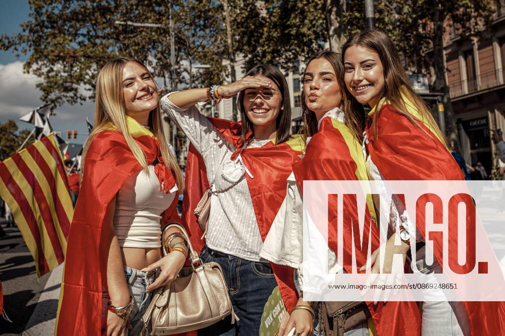 Four women wrapped in Spanish flags pose during a demonstration marking SpainÃ¢â‚¬â ¢s National Day. Barcelona Spain - ZUMAo105 20261012_fap_o105_029