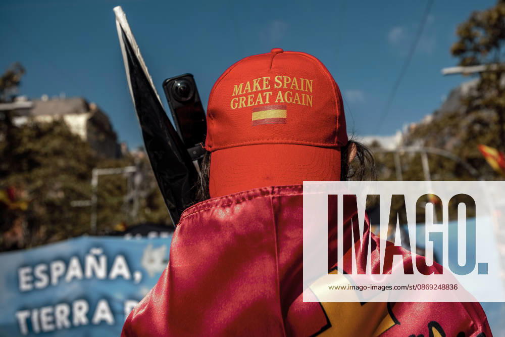 A demonstrator wearing a Make Spain Great Again cap and draped in a Spanish flag is seen during a rally marking SpainÃ¢â‚¬â ¢s National Day. Barcelona Spain - ZUMAo105 20261012_fap_o105_013