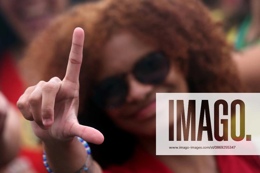 A supporter flashes an L for Lula as thousands of supporters gather in Copacabana, Rio de Janeiro, Brazil, on October 12, 2026, for a pro-democracy demonstration organized by the CENA Nacional movement, the National Union of Students (UNE) and Universibloco. Held on BrazilÃ¢â‚¬â ¢s Our Lady of Aparecida national holiday, the rally calls for the defense of constitutional rights and public policies supporting healthcare, education and social assistance. Carnival street bands, known as blocos, and percussion groups brought music and a festive atmosphere to the waterfront mobilization, blending political activism with RioÃ¢â‚¬â ¢s popular street culture. The demonstration takes place ahe - ZUMAk251 20261012_znp_k251_005