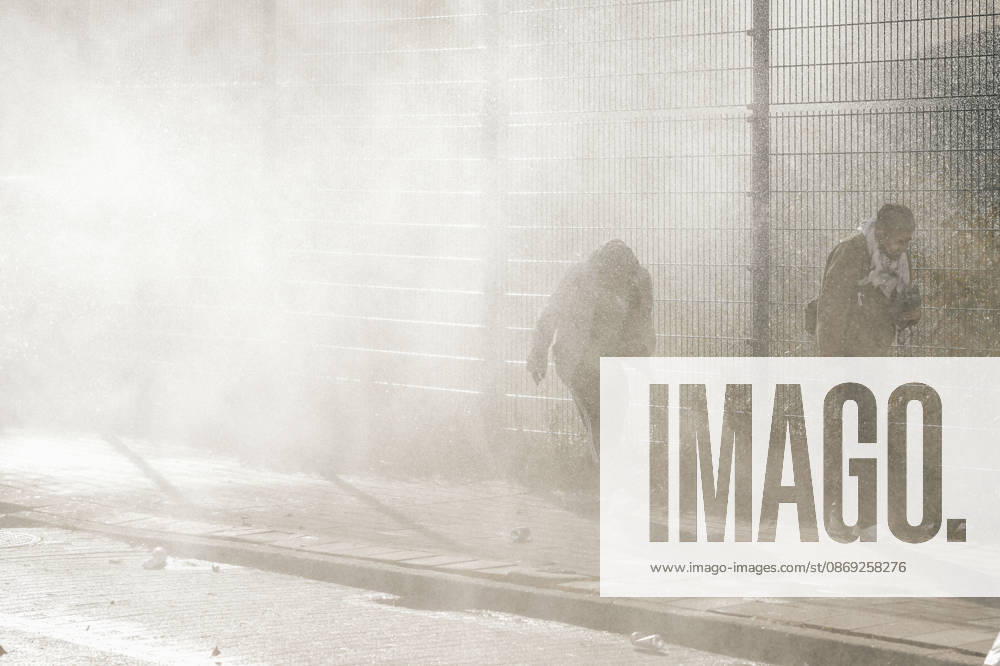 Brussels Belgium Protest People walk past a fenced area amid gas smoke during a protest in Brussels, Belgium on October 12, 2026. Protesters and trade union members stage demonstrations and clash with police during a nationwide public-sector strike against government austerity measures, budget cuts, and reform plans in Brussels, Belgium. Brussels Brussels Capital Belgium