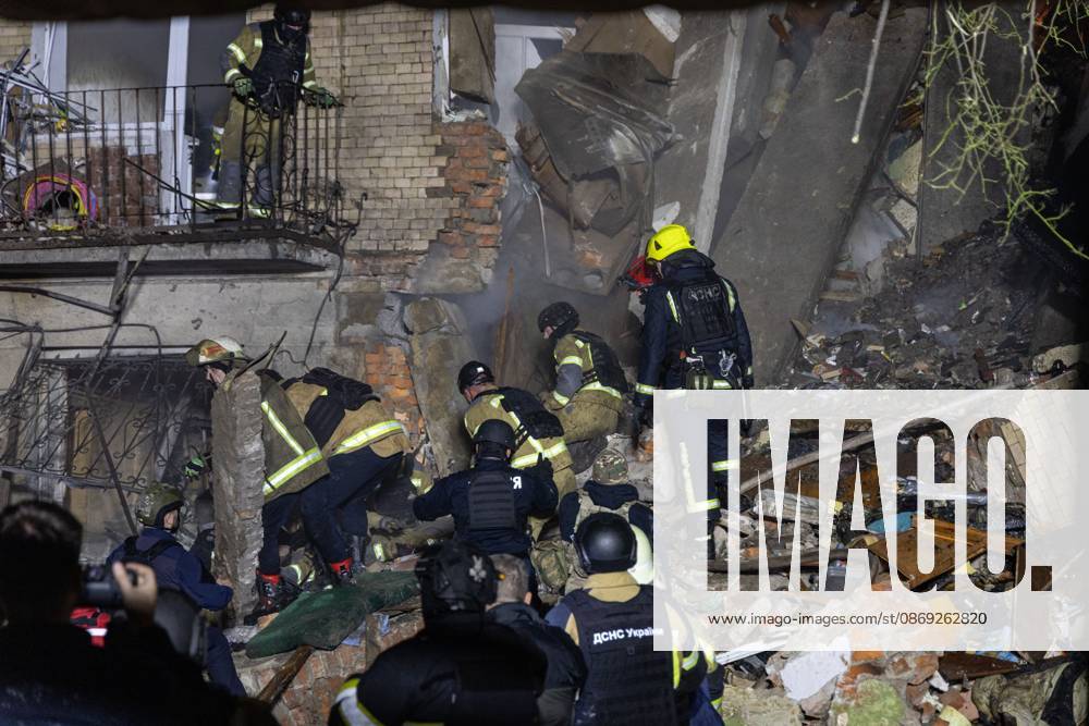 KHARKIV, UKRAINE, OCTOBER 12, 2026: Emergency workers conduct rescue operations at a residential building damaged in a Russian strike in Kharkiv s Kholodnohirskyi district. A firefighter was injured by falling concrete debris while clearing the rubble and was evacuated on a stretcher. Kharkiv Ukraine - ZUMAq101 20261012_zna_q101_142