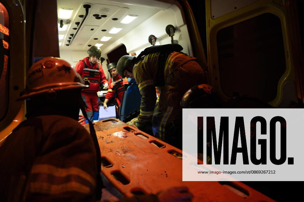 Rescuers load an injured firefighter into an ambulance after a sustained injury clearing debris at a Russian cruise missile strike on a residential area in Kharkiv, Ukraine, 2026. Kharkiv Ukraine - ZUMAm350 20261012_zip_m350_003