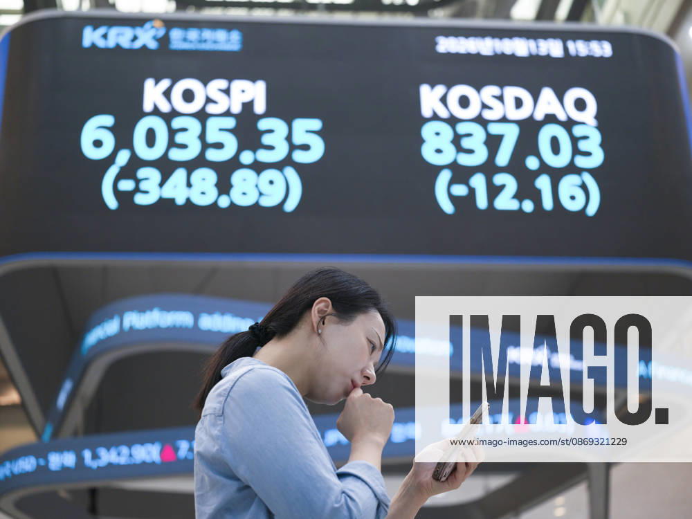 South Korea Stocks Plunge As KOSPI Drops Sharply At KRX In Seoul A Korea Exchange (KRX) employee looks at her smartphone in front of a board displaying the closing KOSPI index at 6,035.35 (-348.89) and KOSDAQ index at 837.03 (-12.16) in Yeouido, Seoul, South Korea, on October 13, 2026. Seoul Seoul South Korea