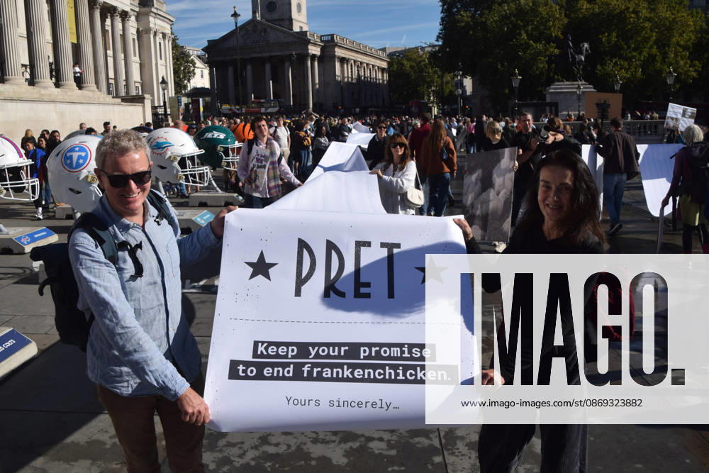 Protesters pass through Trafalgar Square with a long pledge to boycott Pret signed by 100,000 people during the march to Pret headquarters urging the fast food chain to drop Frankenchickens. Frankenchickens are chickens mostly raised on factory farms who are bred to grow much faster and who are said to suffer far more than regular chickens. London United Kingdom - ZUMAv130 20261013_zip_v130_026