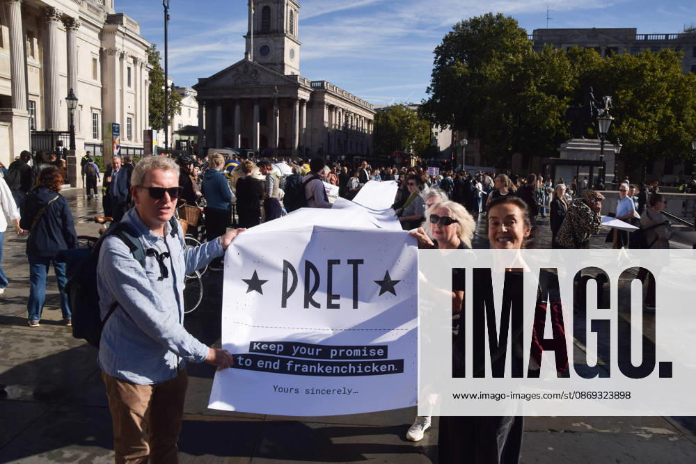 Protesters pass through Trafalgar Square with a long pledge to boycott Pret signed by 100,000 people during the march to Pret headquarters urging the fast food chain to drop Frankenchickens. Frankenchickens are chickens mostly raised on factory farms who are bred to grow much faster and who are said to suffer far more than regular chickens. London United Kingdom - ZUMAv130 20261013_zip_v130_028
