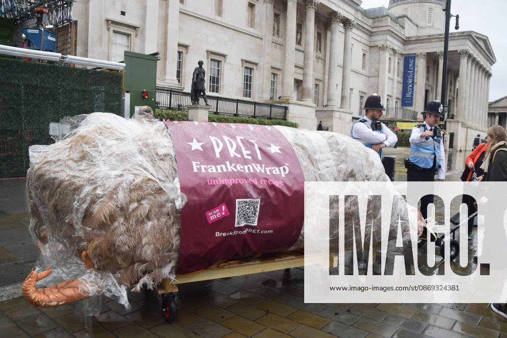 Protesters pass through Trafalgar Square with a giant wrapped chicken during the march to Pret headquarters urging the fast food chain to drop Frankenchickens. Frankenchickens are chickens mostly raised on factory farms who are bred to grow much faster and who are said to suffer far more than regular chickens. London United Kingdom - ZUMAv130 20261013_zip_v130_027